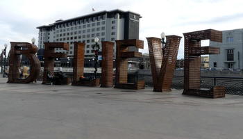 Metal grid sculpture spelling out “BELIEVE” in lettes approx. 2 meters high