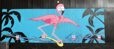 Pink flamingo on skateboard