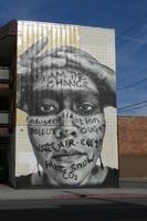 Man with hands on top of head; text in part reads “I am the change”