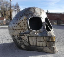 Large metal sculpture of a skull