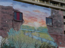 Partial landscape painted on brick building