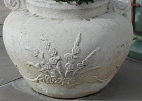 Flower relief on white stone planter
