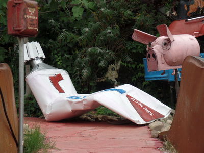 Sculpture of toothpaste tube and a pig-shaped mailbox