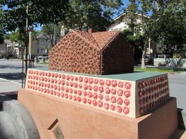 House made of tiles with roses on them. Title is “Neighborhoods”