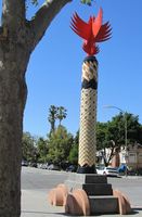 Column with large red bird-like sculpture at top