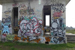 Various graffitti on side of buildling exterior