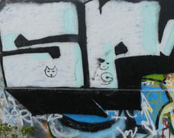 Graffittied letters with small cat face