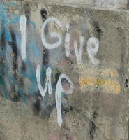 “I give up” spray painted on wall