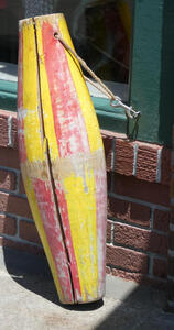 Wooden bouy with red and yellow stripes