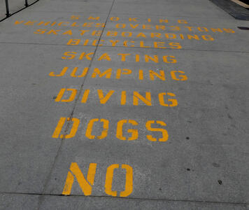 Stenciled warnings on sidewalk