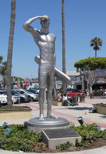 Silver statue of lifeguard looking out to the ocean