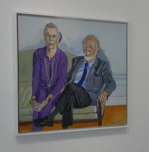Portrait of elderly couple; woman in purple dress, man in gray suit, both sitting on a couch