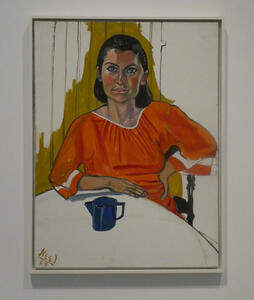 Woman in orange blouse sitting at table