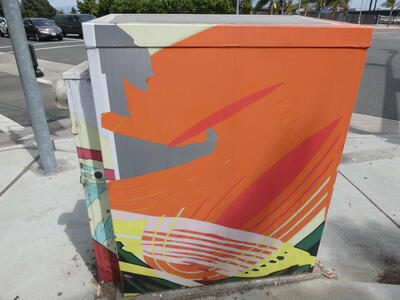 Mostly orange abstract art on utility box.