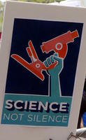 Fist holding microscope: Science, not silence