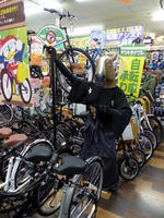 Mannequin with horse head mask advertising bicycles