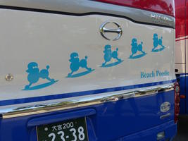 bus with blue poodle on surfboard