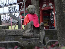 buddha statue with red bib
