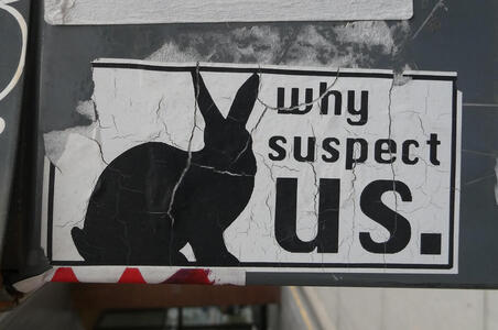 Sticker showing silhouette of a rabbit with text: Why suspect us.