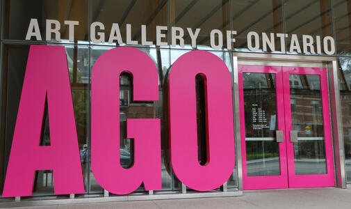 Entrance to Art Gallery of Ontario, with large purple letters AGO