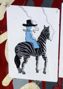 animal in cowboy hat on zebra