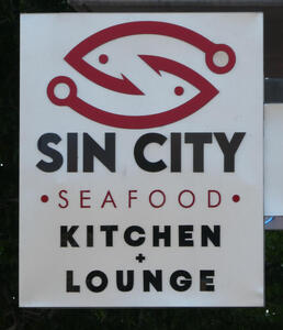 Interlocking outline of fish; logo for Sin City Seafood