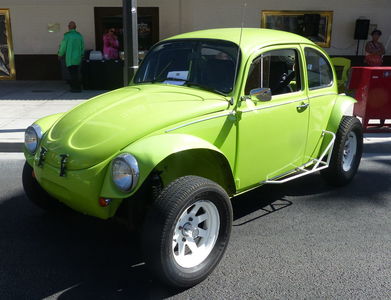 Lime-green VW beetle with large tires