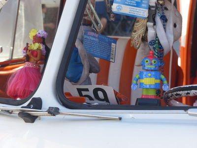 Hula girl and toy robot on dashboard of VW van