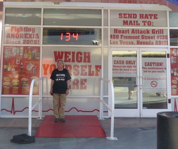 Me on scale in front of Heart Attack Grill (weight 134 lb)