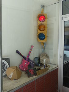 Window display in hacker space: traffic signal, guitars, etc.