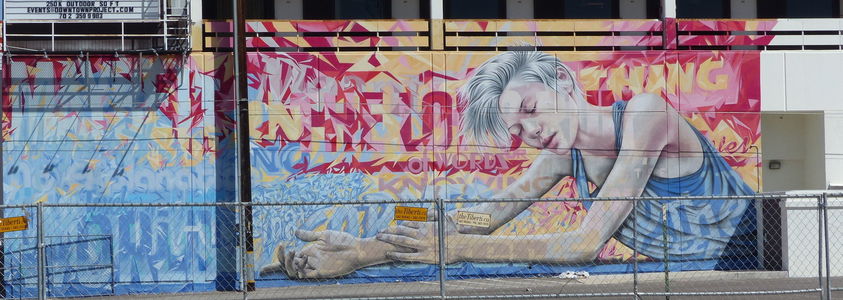 Woman with white-blond hair and tank top (mural on building)