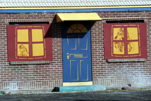 Painted “doors” and “windows” on boarded-up hotel