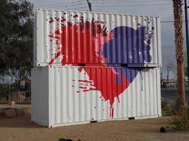 red and blue heart painted on side of two stacked containers