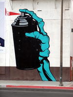 Teal skeleton hand holding spray paint can