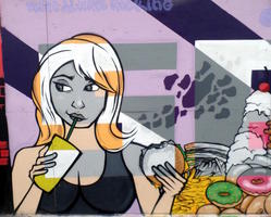 Mural panel showing woman drinking soda and holding hamburger