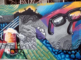 Mural panel showing glasses, tropical island, and mug of beer.