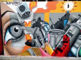 Mural panel with large eye, paint can, and spray paint cans