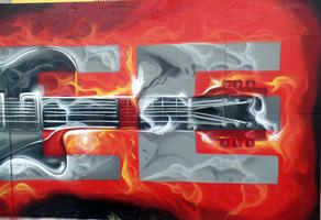 Mural panel showing guitar superimposed on letters “SEE”