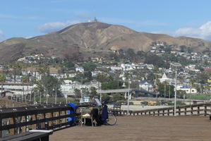 View from pier back to city with mountain in background and houses in foreground