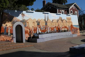 Mural showing people from the late 1800s in a street scene