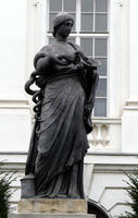 Roman-style statue of woman holding snake drinking from bowl