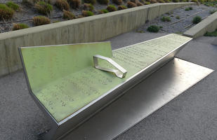 Green metal bench with braille notation