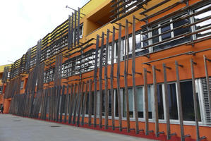 Yellow-to-orange building with wood slats on exterior