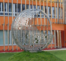 Metal spherical shell with names of famous people associated with the university.