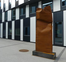 Rust-colored crumpled rectangular sculpture