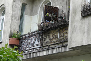 Flower pots on balcony with wrought iron decoration