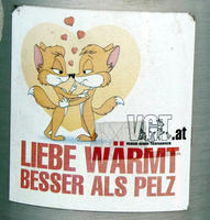 Two cartoon animals embracing, with hearts surround them. Text: Love warms better than fur.