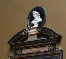 Bust of man in niche on wall above door