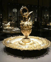 Ornate gold jar on gold plate