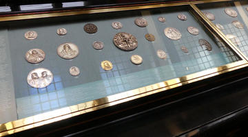 Display case of large medallions